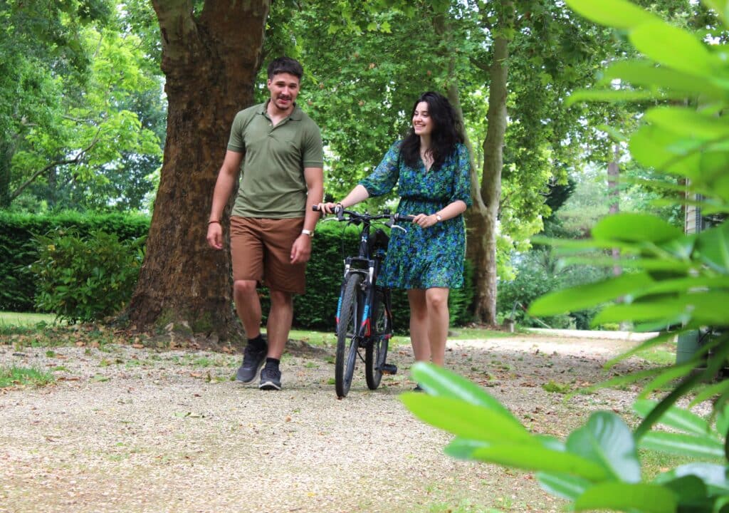 Couple en promenade à vélo dans un charmant camping dans le Gers